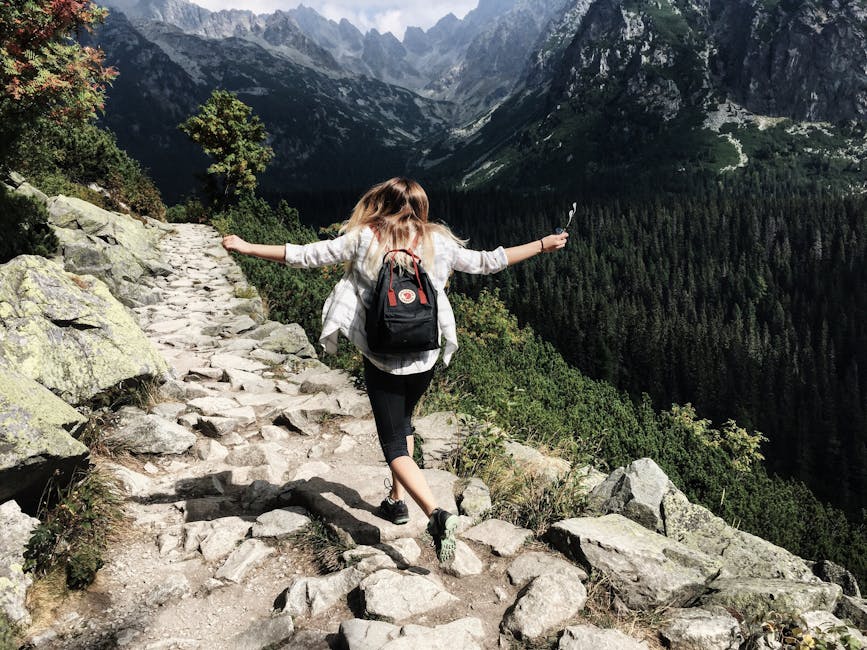Woman hikes along rocky path in Vysoké Tatry, Slovakia